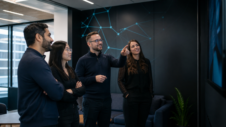 Technology professionals sharing an Atomic Guardian business update