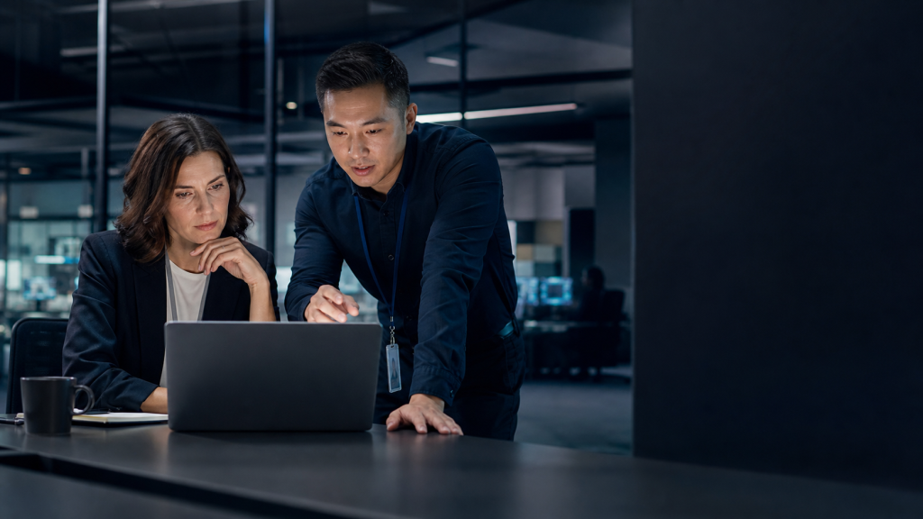Business professional and IT specialist reviewing a suspicious payment request